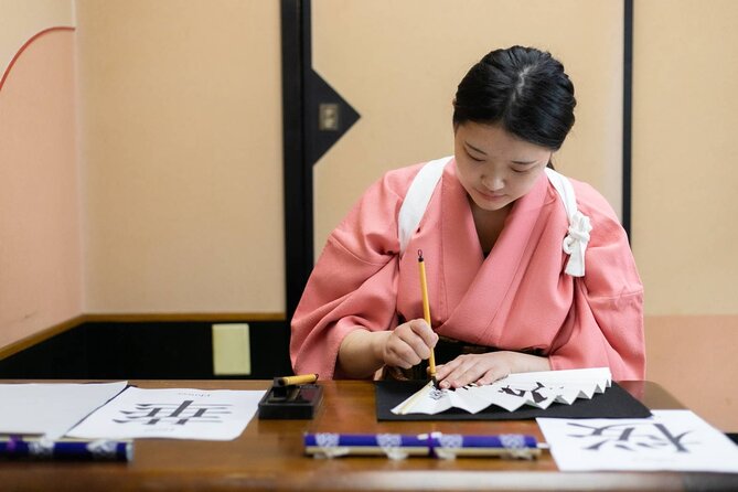 Learning Zen of Japanese Calligraphy in kimono near Osaka Castle - The core strokes: tome, hane, and harai in real practice
