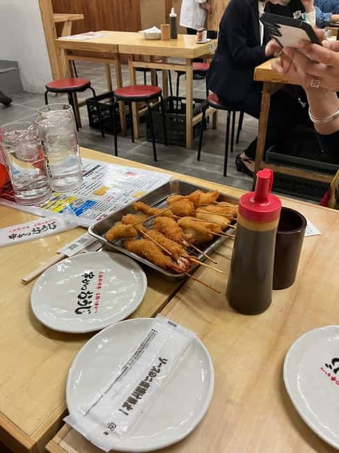 Osaka: Private and Fully Customized Tour with Hotel Meet Up - Shinsekai: neon nostalgia with a guide doing the explaining
